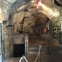 A vaulted chamber cut into the rock beneath the streets.